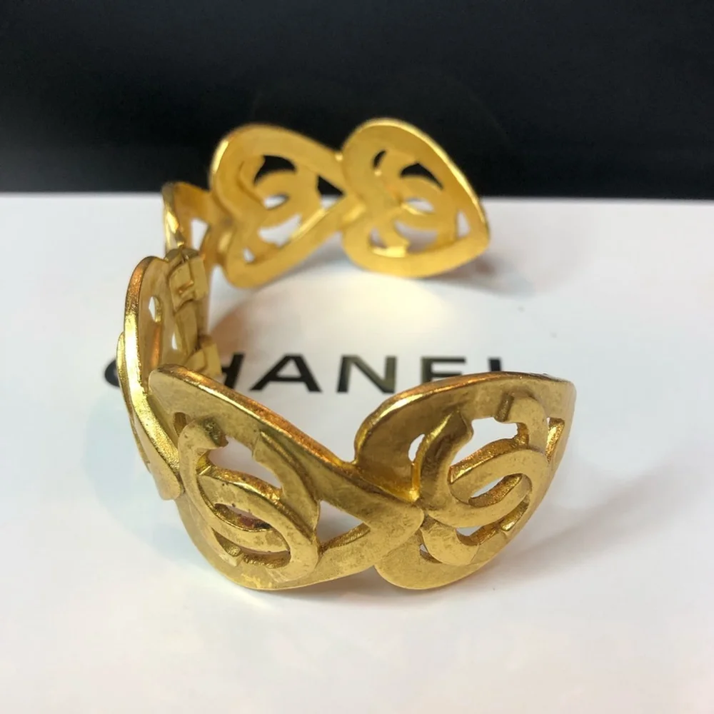 CHANEL Gold Cuff Bracelet with Interlocking CC Open Heart Design